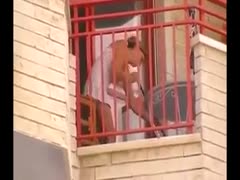 On the balcony, a cute little neighbor with golden hair was videotaped wearing an upskirt.